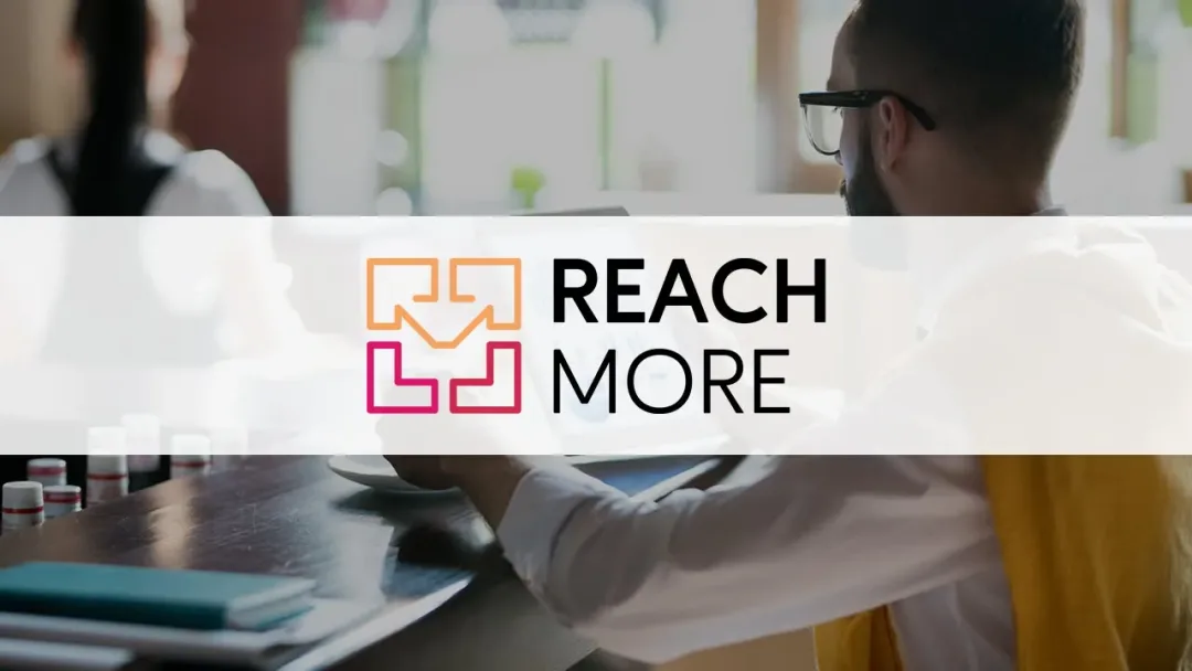 The ReachMore logo over a photo of a team at work