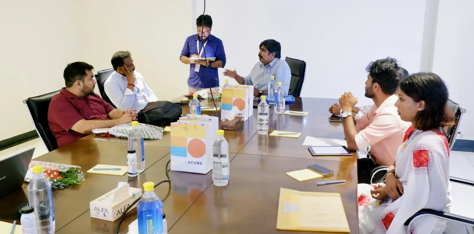 The team at a meeting table in the office
