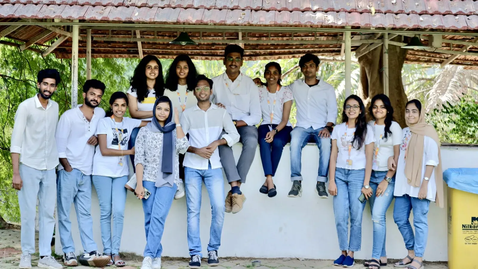 The team seated together outdoors