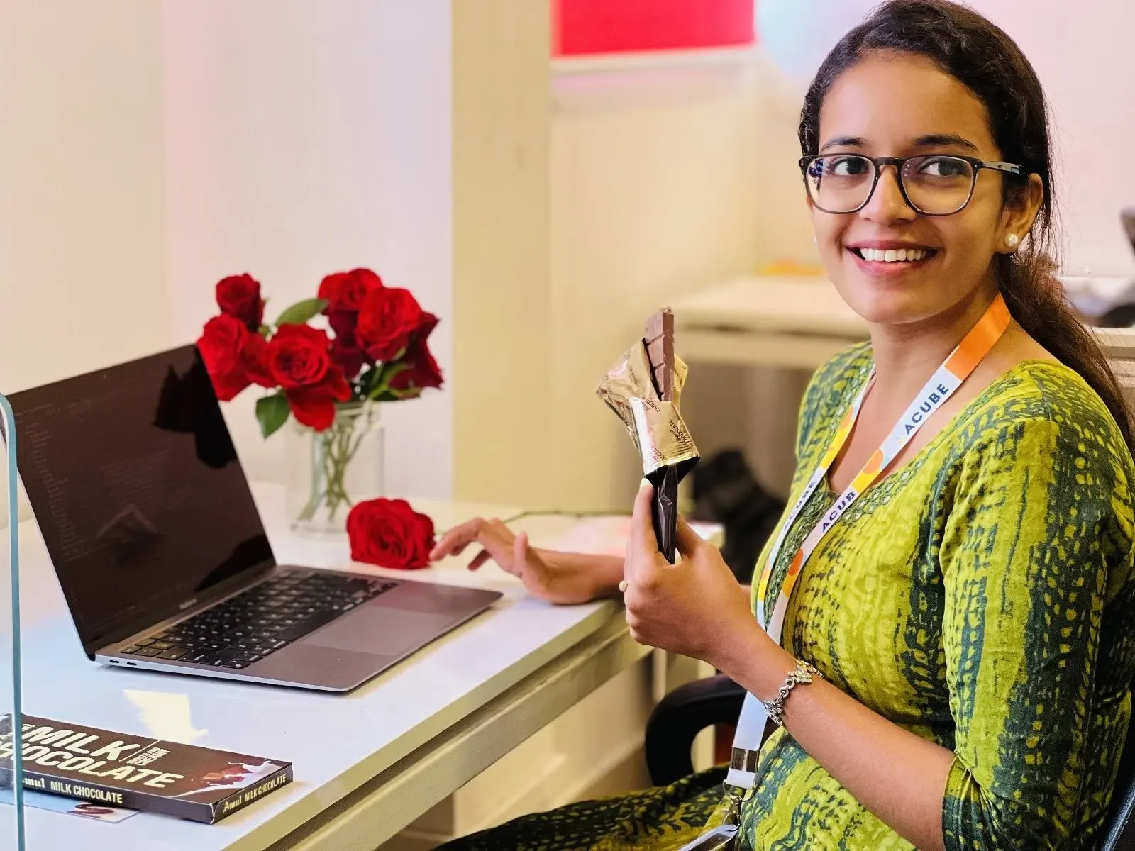 A colleague with a rose at her desk