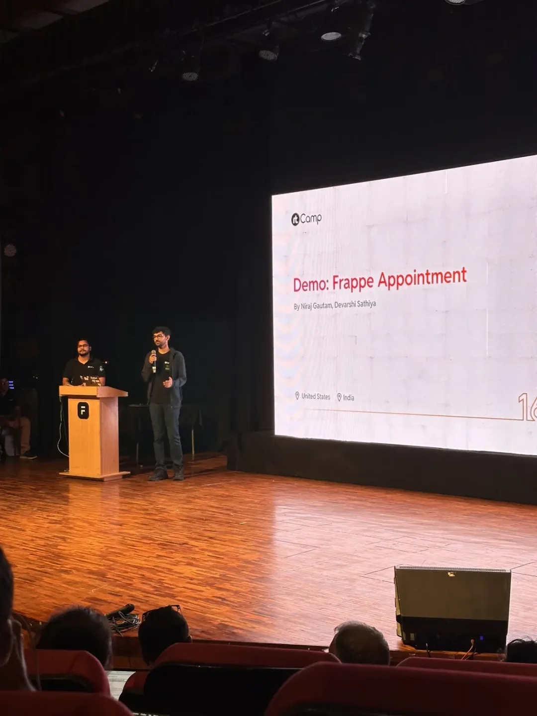 A talk on stage at Frappe Build 2025