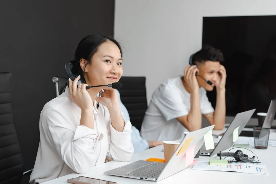 AI Chatbots That Answer, Qualify & Sell 24/7 — customer support agent laptop headset office, by Acube Innovations, an ERPNext & software development company in India
